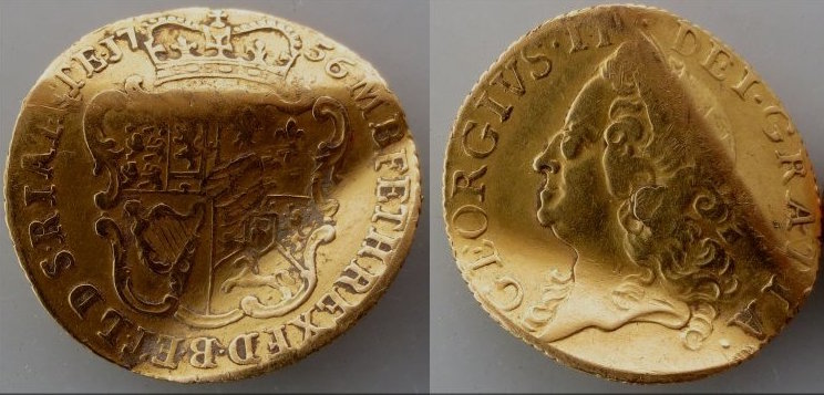 An image showing the front and back of an old coin, bent in an S shape. Thus, making it a love token.